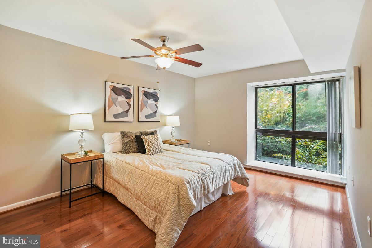 2102 Green Watch Way, Unit 301 Reston, VA 20191 - Photo 23 of 32 a bedroom with a large bed and a window