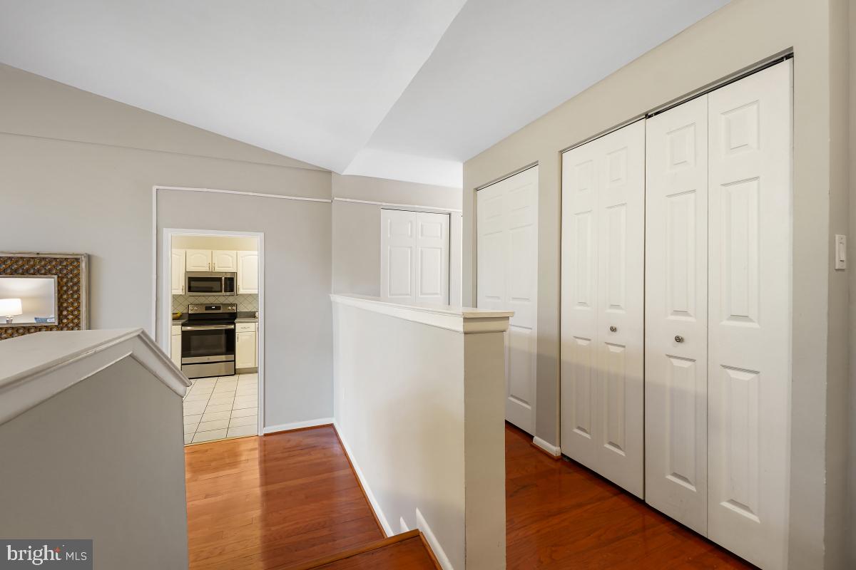 2102 Green Watch Way, Unit 301 Reston, VA 20191 - Photo 5 of 32 a view of a hallway with wooden floor and livingroom