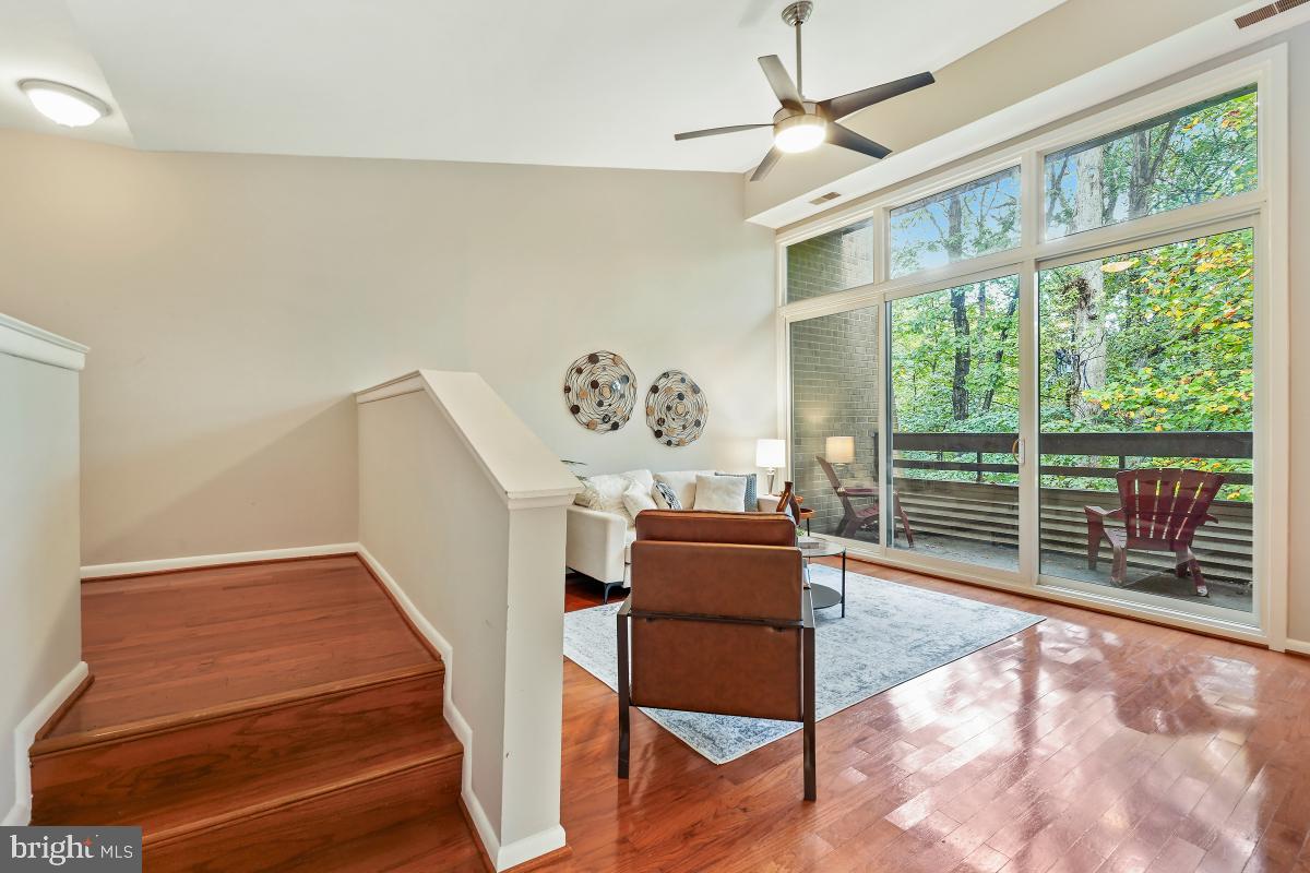 2102 Green Watch Way, Unit 301 Reston, VA 20191 - Photo 6 of 32 a view of a livingroom with furniture wooden floor and a ceiling fan