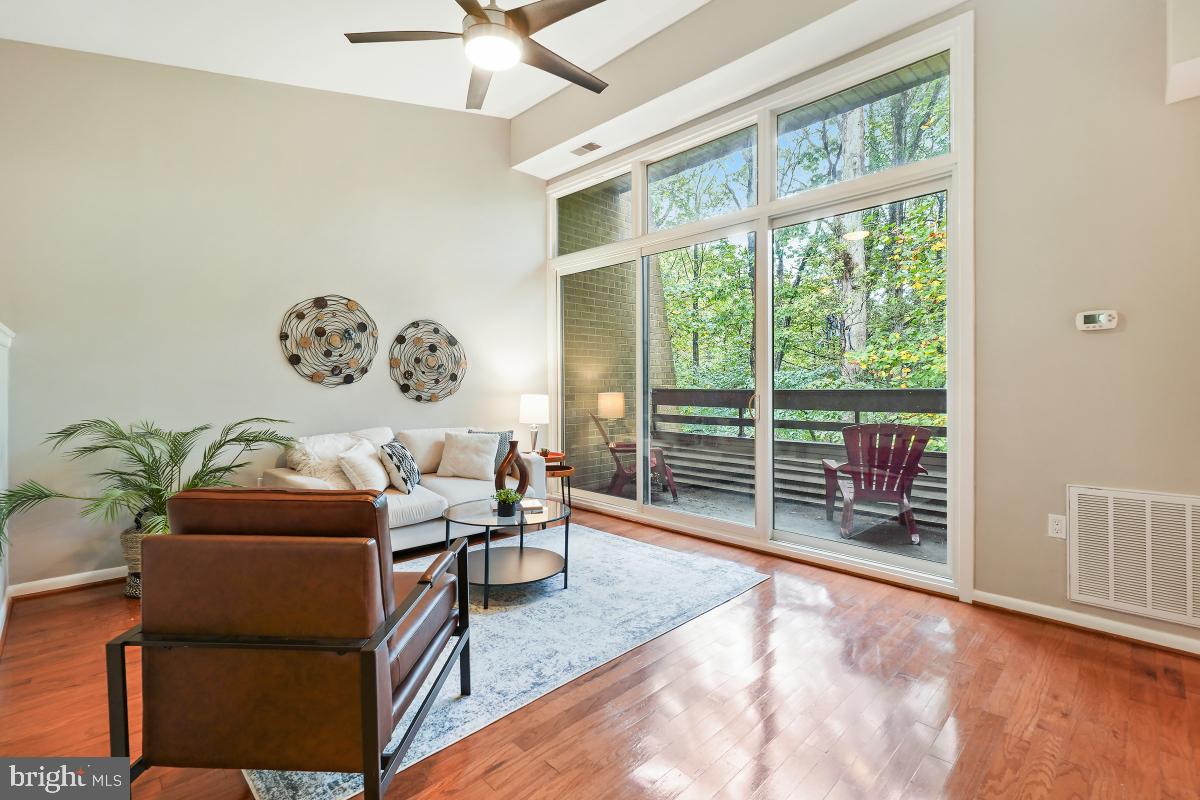 2102 Green Watch Way, Unit 301 Reston, VA 20191 - Photo 7 of 32 a living room with furniture and a large window