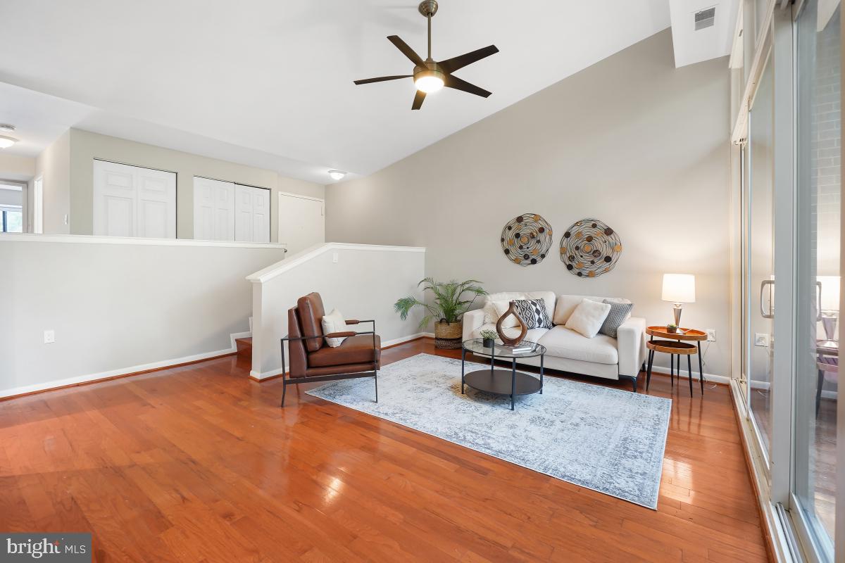2102 Green Watch Way, Unit 301 Reston, VA 20191 - Photo 9 of 32 a living room with furniture and a rug