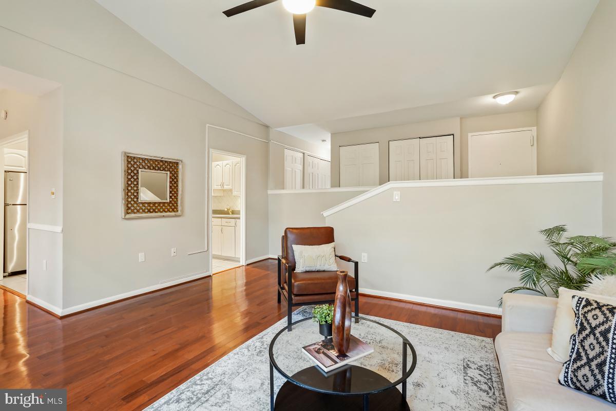 2102 Green Watch Way, Unit 301 Reston, VA 20191 - Photo 10 of 32 a living room with furniture and a chandelier