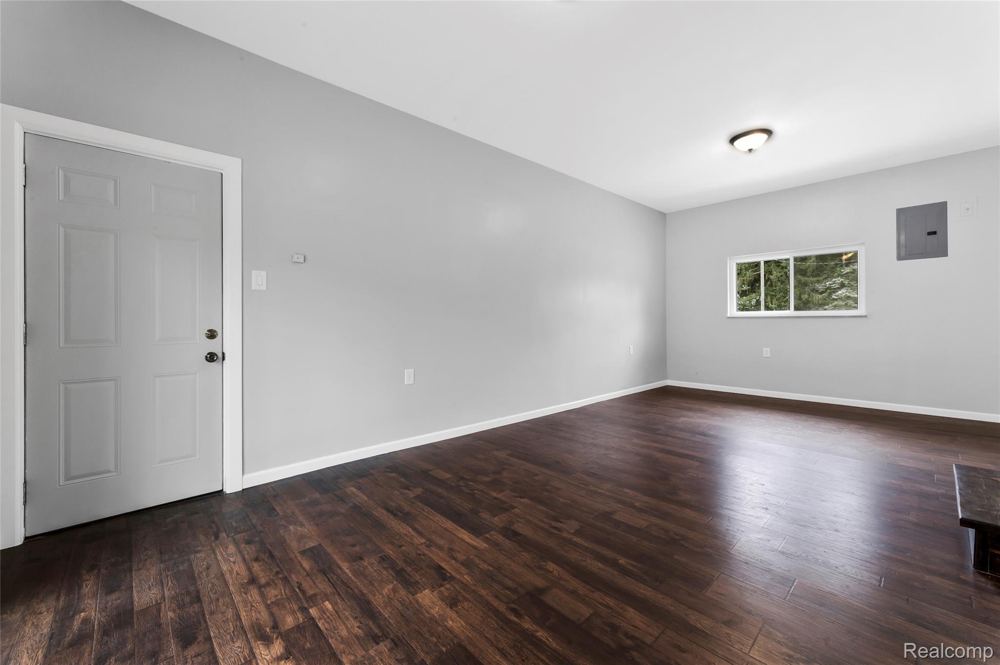 13515 Lenmoore Road Belleville, MI 48111 - Photo 16 of 41 Spare room featuring dark wood-style flooring and electric panel