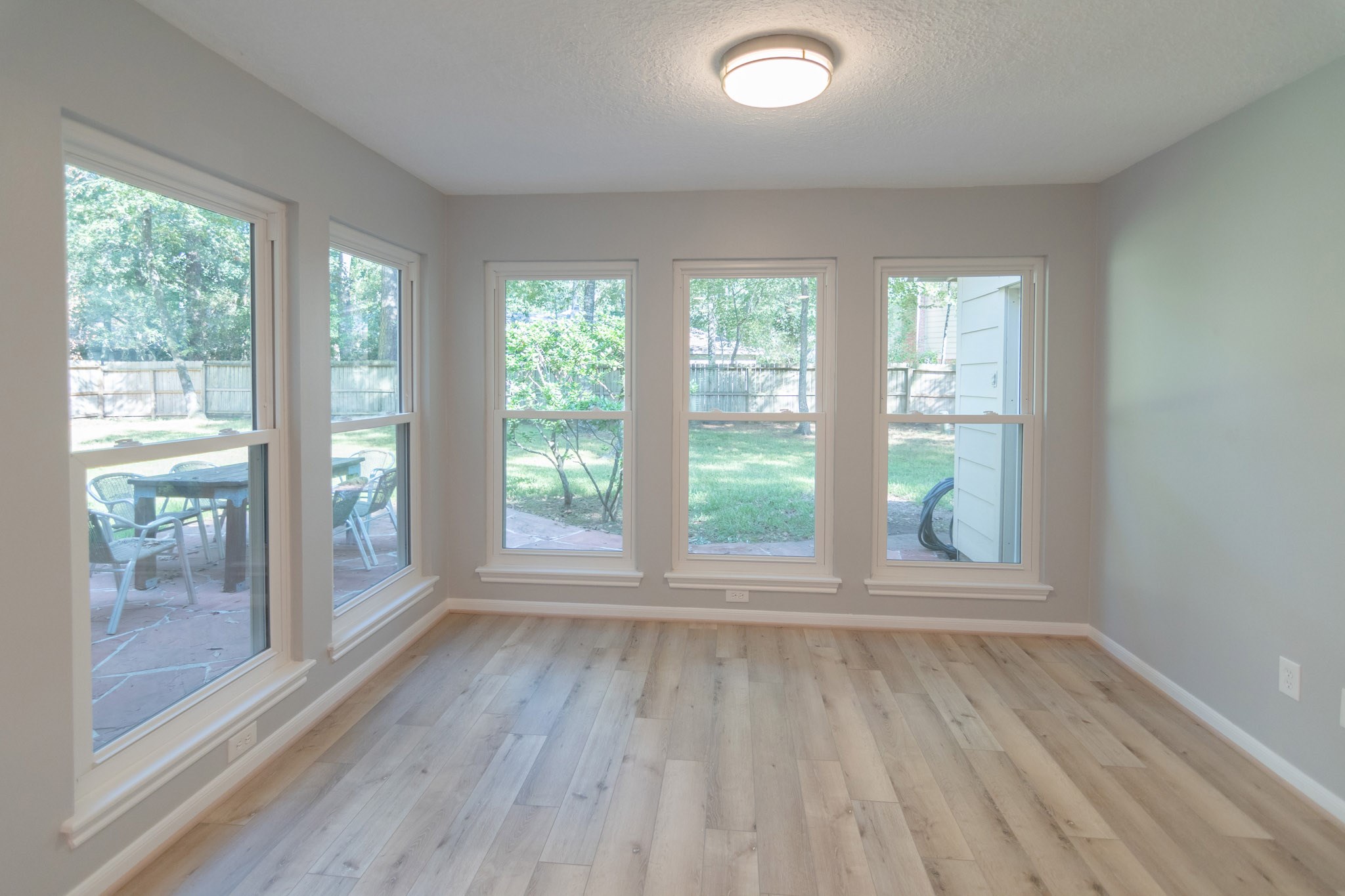 10 Coralvine Court Spring, TX 77380 - Photo 16 of 34 Breakfast room has pleasing soft gray walls, beautiful light wood flooring and great windows.