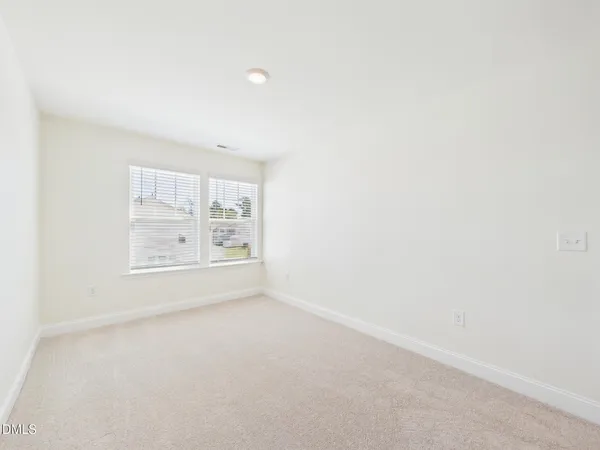 a view of a room with wooden floor outdoor space and windows