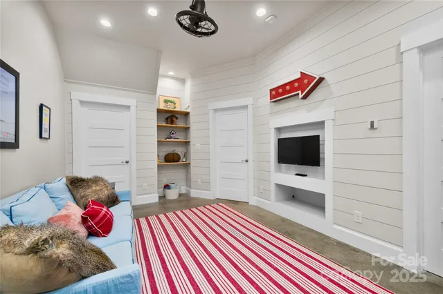 a bedroom with furniture and a flat screen tv