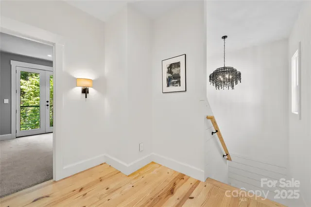 a view of a room with wooden floor and windows