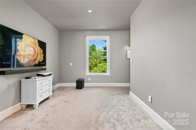 a living room with window furniture and a flat screen tv