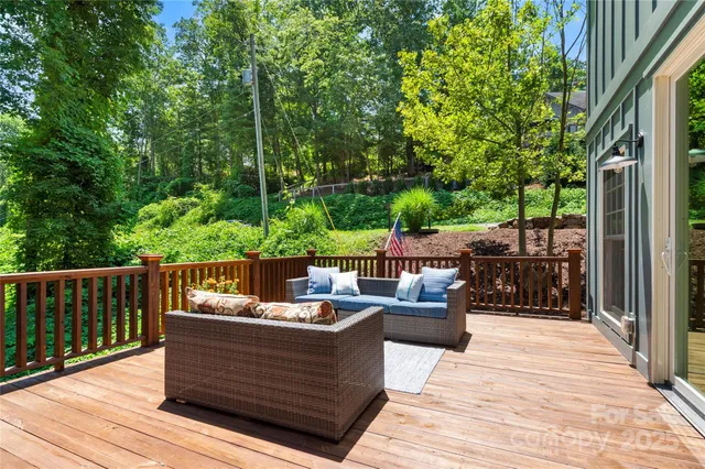 a view of a patio with couches chairs and wooden floor