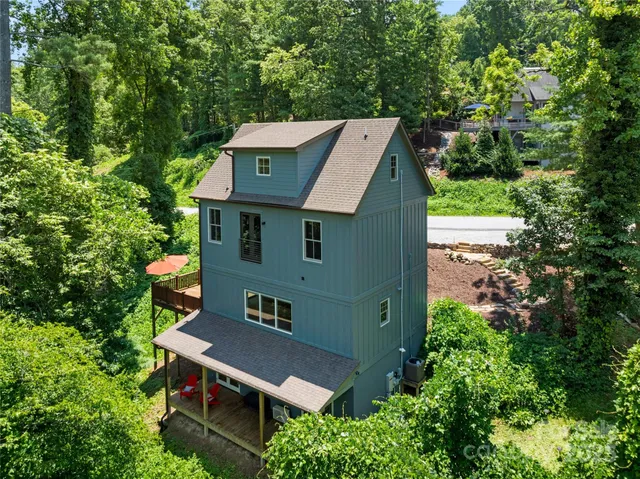 an aerial view of a house with a yard