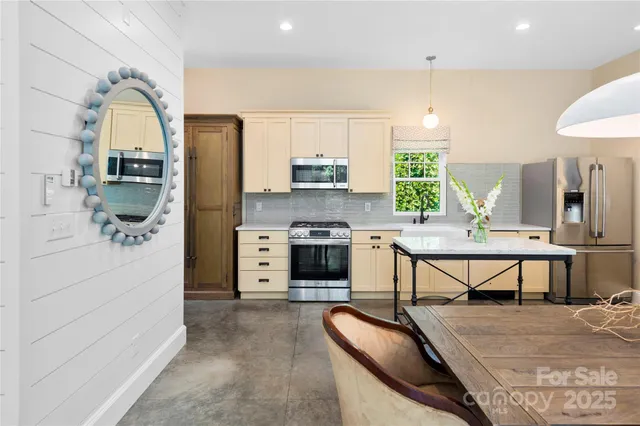 a living room with furniture a fireplace and a table