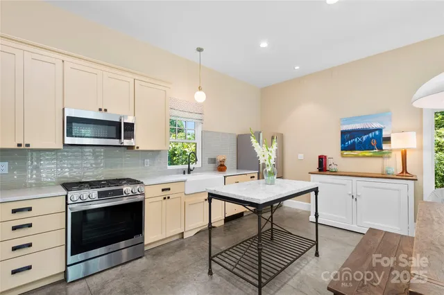 a kitchen with a stove a sink and a microwave