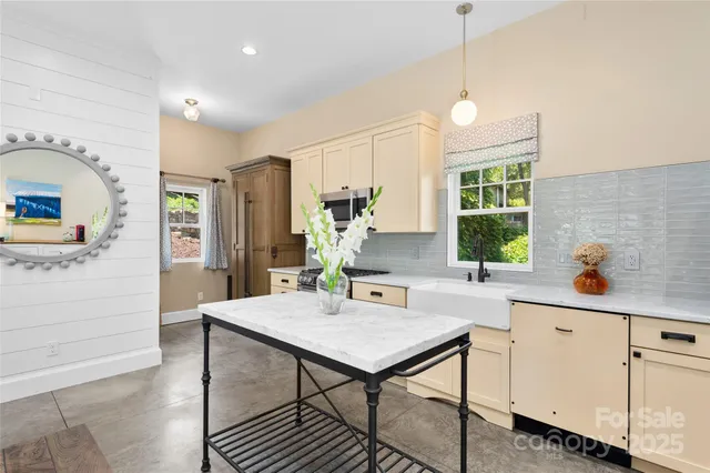 a view of a kitchen area with furniture and wooden floor