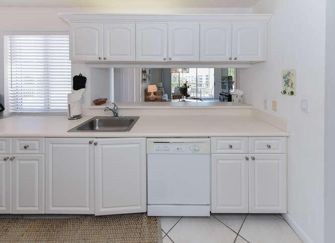 353 Highway 1, Unit F306 Jupiter, FL 33477 - Photo 11 of 43 a kitchen with white cabinets and white appliances