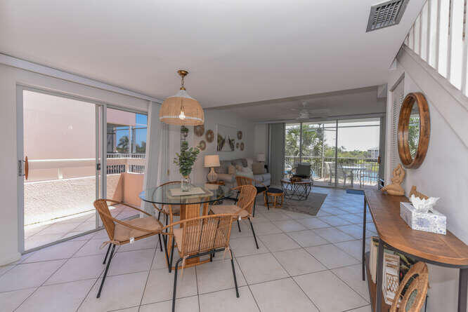 353 Highway 1, Unit F306 Jupiter, FL 33477 - Photo 15 of 43 a dining room with furniture a chandelier and wooden floor