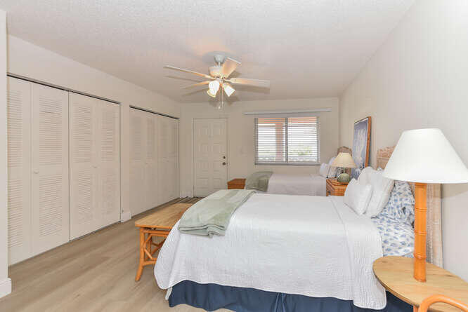 353 Highway 1, Unit F306 Jupiter, FL 33477 - Photo 27 of 43 a bedroom with a bed and a chandelier
