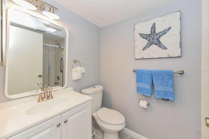 353 Highway 1, Unit F306 Jupiter, FL 33477 - Photo 28 of 43 a bathroom with a toilet a sink and mirror