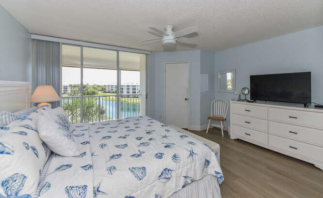 353 Highway 1, Unit F306 Jupiter, FL 33477 - Photo 31 of 43 a bedroom with a bed and a flat screen tv