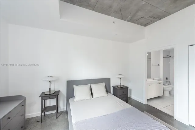 a bedroom with a bed and a table