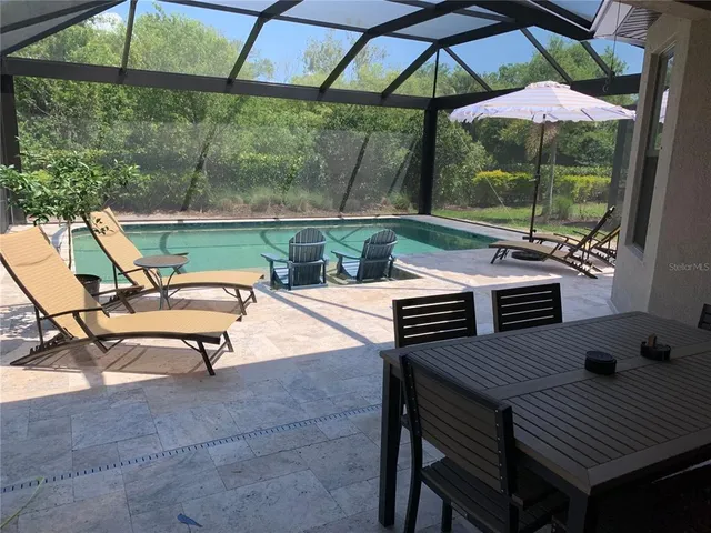 a view of a room with wooden floor and chandelier