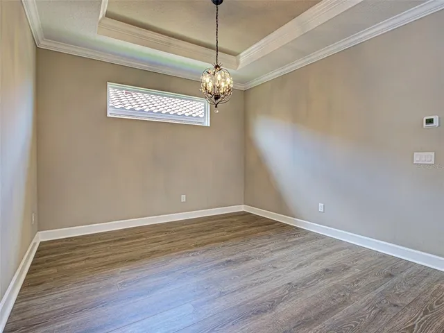 an aerial view of residential houses with outdoor space and parking