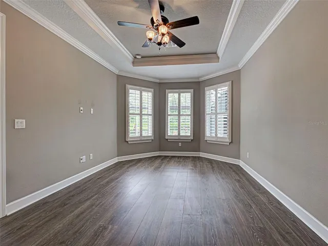 a view of a patio with table and chairs under an umbrella