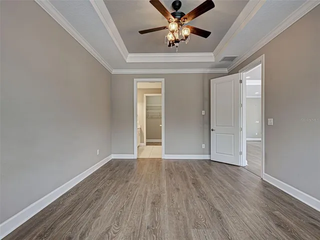 a view of a patio with a table and chairs under an umbrella