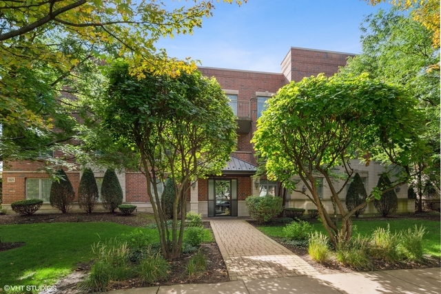 1021 Peterson Avenue, Unit 202 Park Ridge, IL 60068 - Photo 1 of 1 front view of a house with a garden