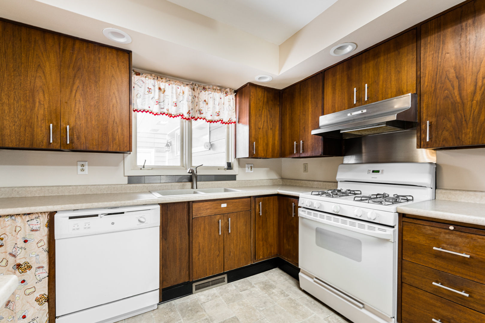 519 Normal Road DeKalb, IL 60115 - Photo 14 of 43 a kitchen with a stove sink and cabinets
