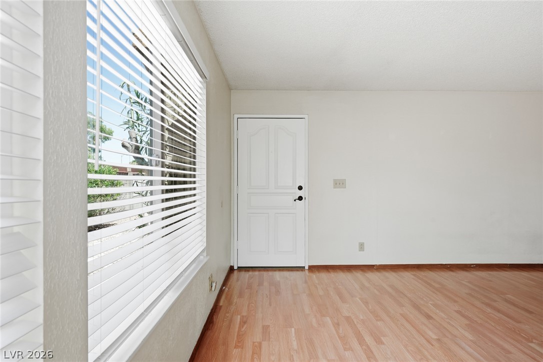 3971 Spring Leaf Drive Las Vegas, NV 89147 - Photo 11 of 48 A welcoming entry features gleaming wood-look flooring and a bright window with privacy blinds.