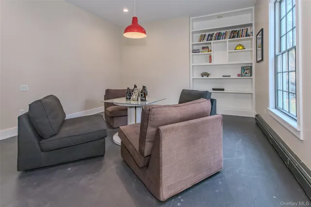 a living room with furniture cabinets and window