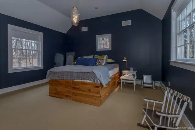 a bedroom with a bed chair and window