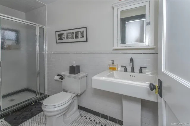 a white toilet sitting next to a bathroom sink