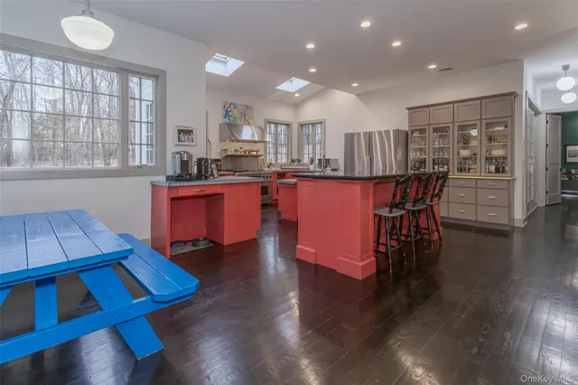 a kitchen with stainless steel appliances wooden floors and wooden cabinets