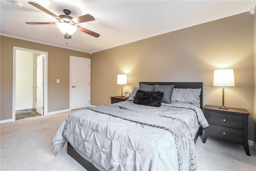 5021 Ripley Lane North, Unit 209 Renton, WA 98056 - Photo 8 of 19 a bedroom with a bed and a lamp