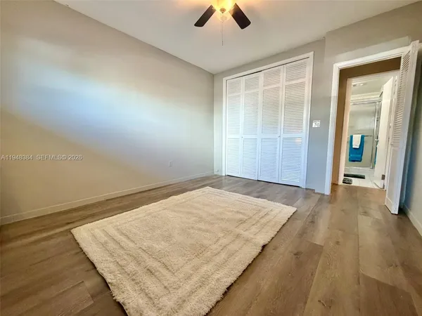 an empty room with wooden floor and closet