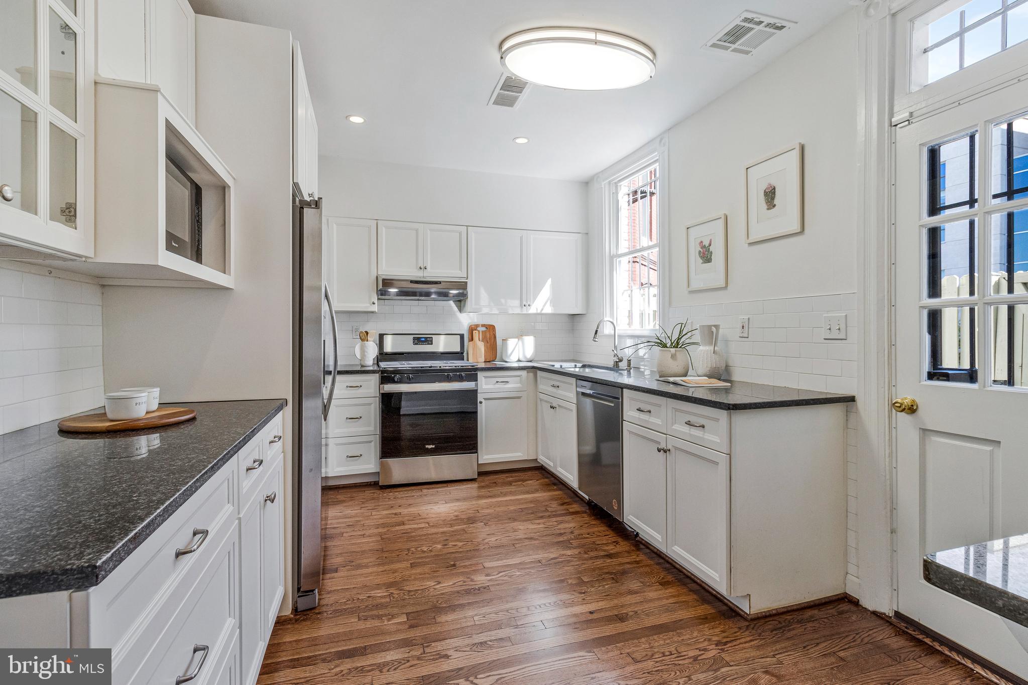 334 E Street Northeast Washington, DC 20002 - Photo 12 of 32 a kitchen with granite countertop a sink and cabinets