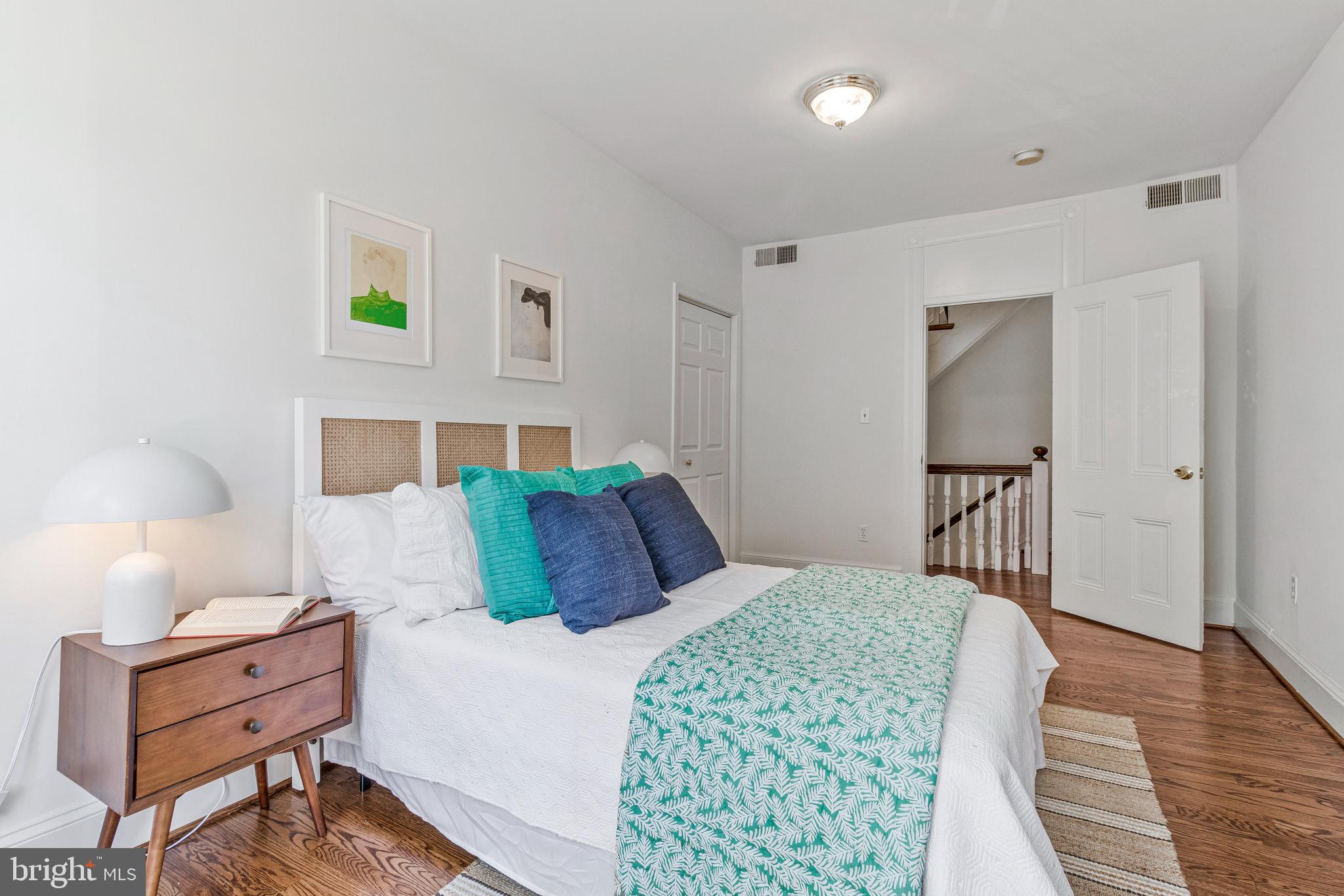 334 E Street Northeast Washington, DC 20002 - Photo 17 of 32 a bedroom with a bed and a lamp on dresser