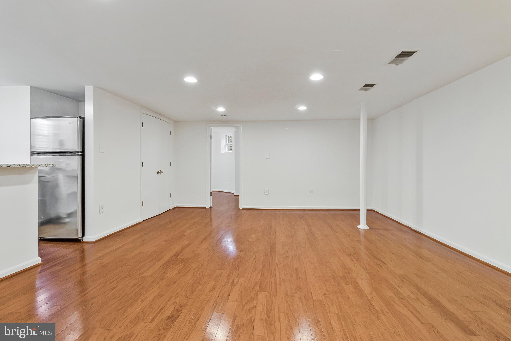 334 E Street Northeast Washington, DC 20002 - Photo 29 of 32 a view of an empty room with wooden floor and a window
