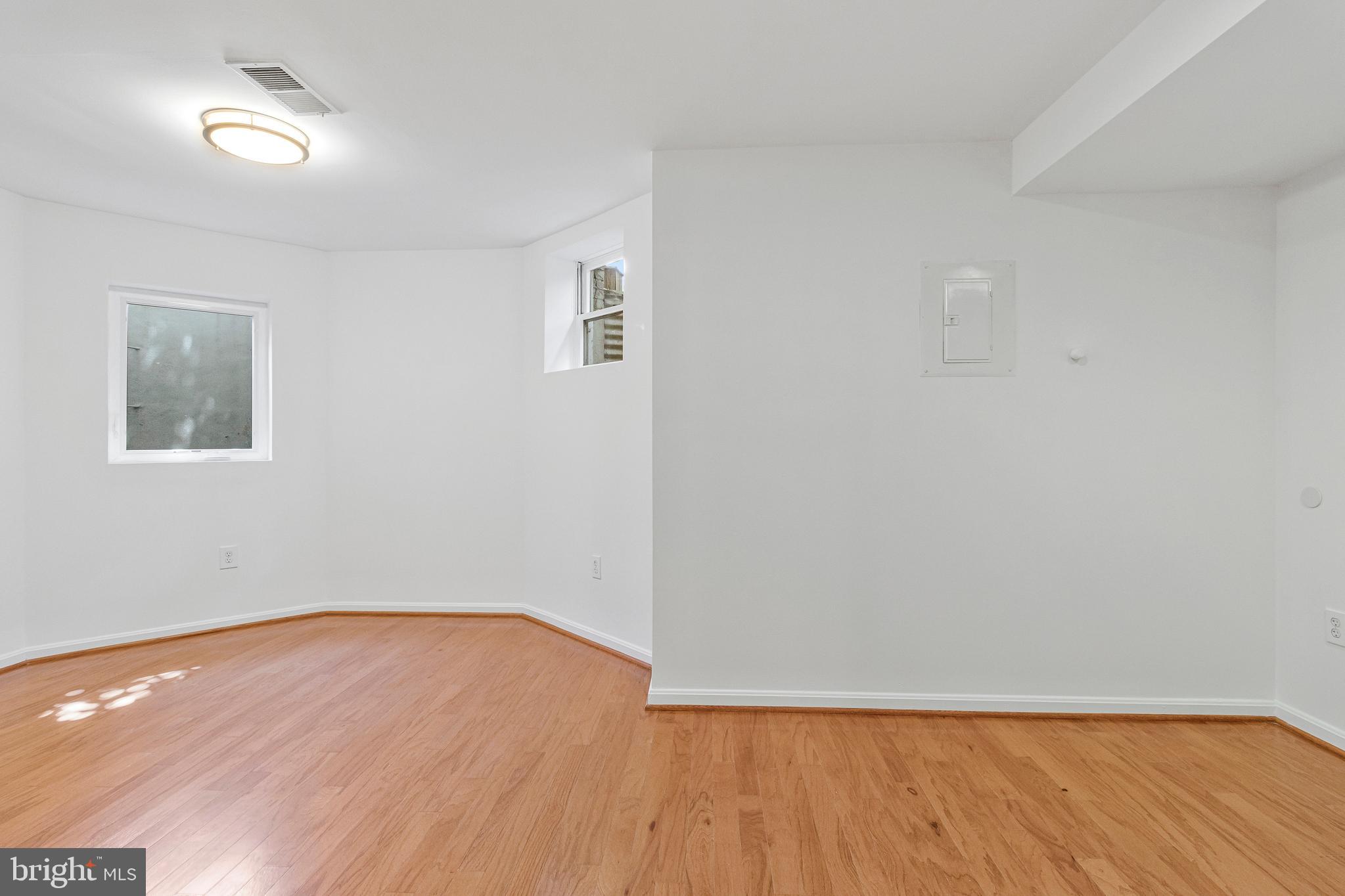 334 E Street Northeast Washington, DC 20002 - Photo 32 of 32 a view of an empty room with wooden floor and a window