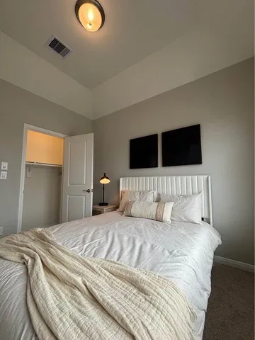 a kitchen with a refrigerator and a stove top oven