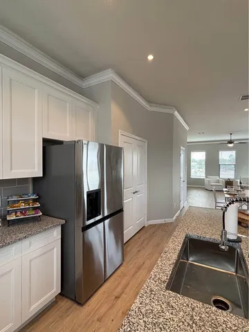 a view of entryway and hall with wooden floor