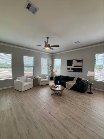 a dining room with furniture and wooden floor