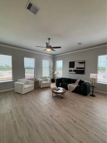 a dining room with furniture and wooden floor