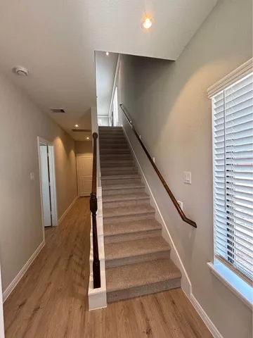 a kitchen with granite countertop wooden cabinets and a stove