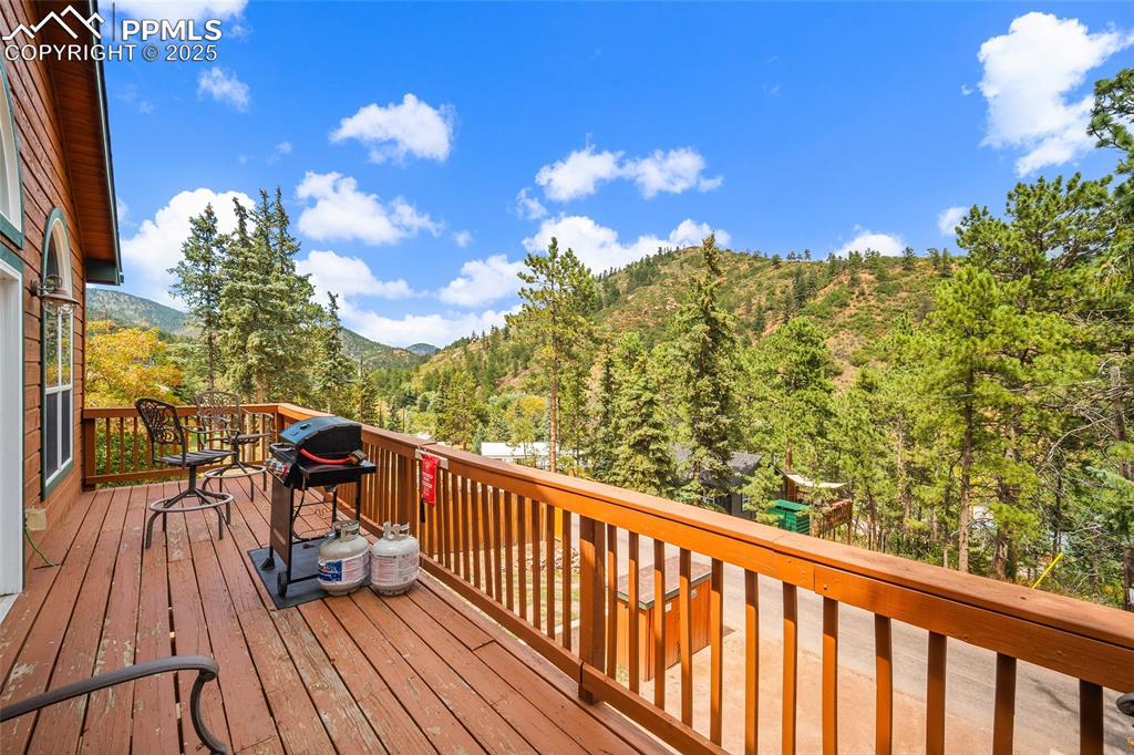 9845 Mesa Road Cascade, CO 80809 - Photo 12 of 50 a view of a balcony with wooden floor and iron fence