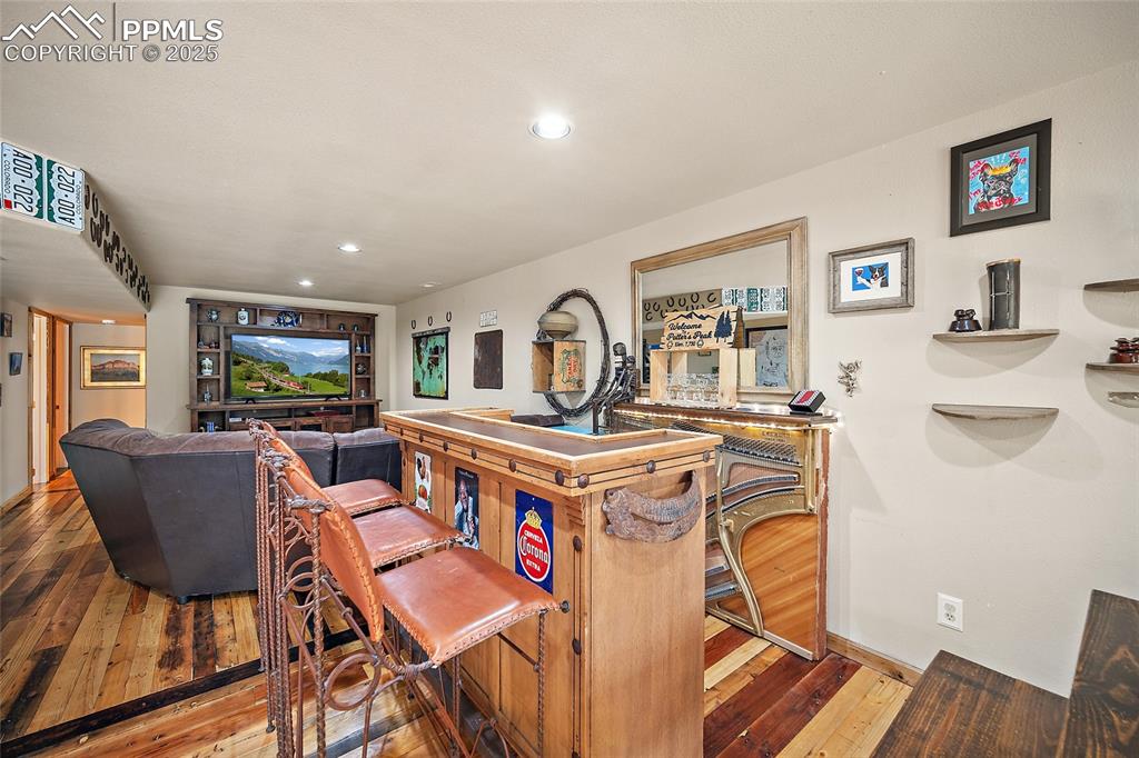 9845 Mesa Road Cascade, CO 80809 - Photo 22 of 50 a living room with furniture a flat screen tv and a table