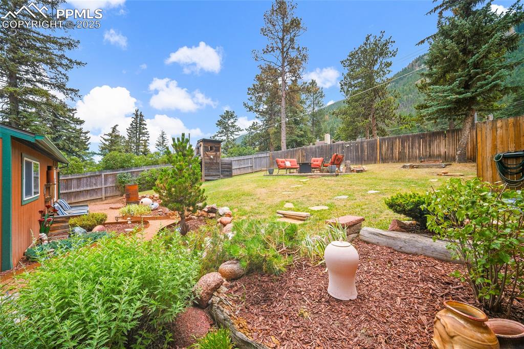 9845 Mesa Road Cascade, CO 80809 - Photo 30 of 50 a view of a backyard with swimming pool