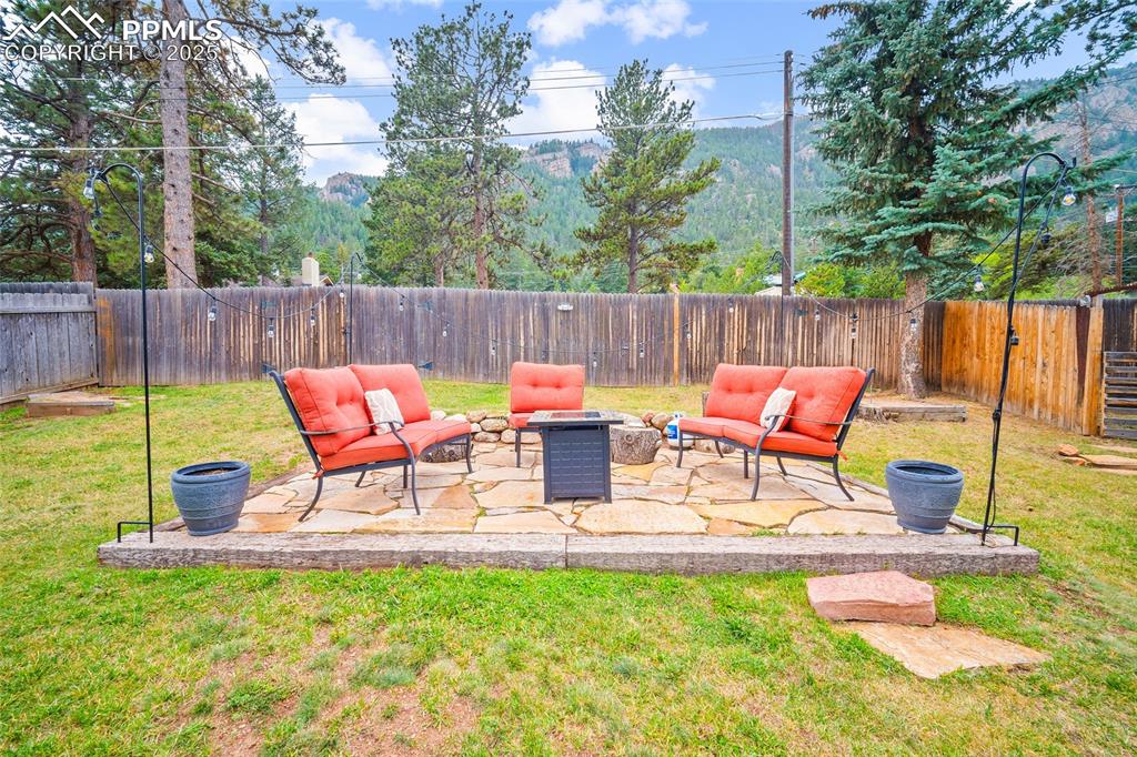 9845 Mesa Road Cascade, CO 80809 - Photo 31 of 50 a view of back yard with table and chairs