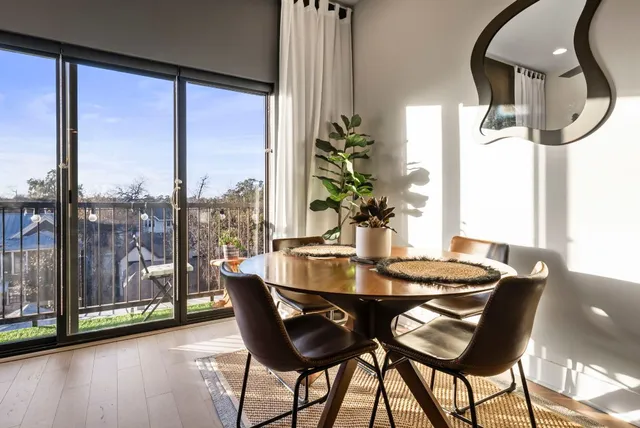 a dining room with furniture and wooden floor